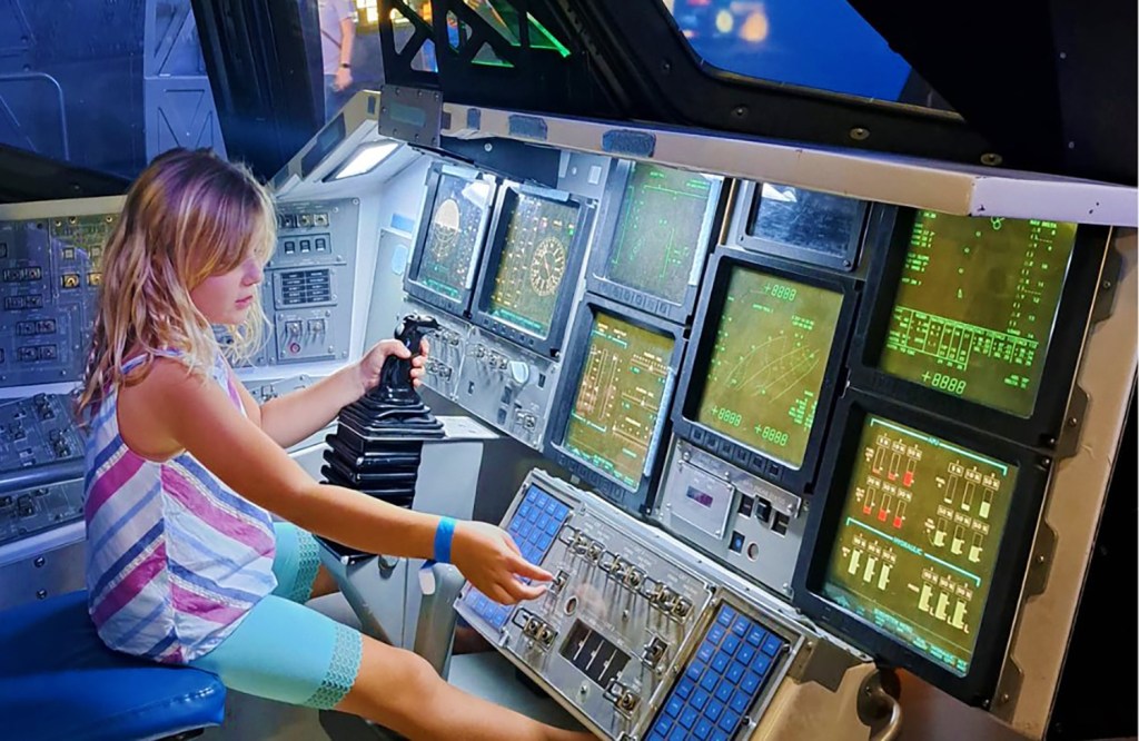 Girl sitting in the cockpit of a plane